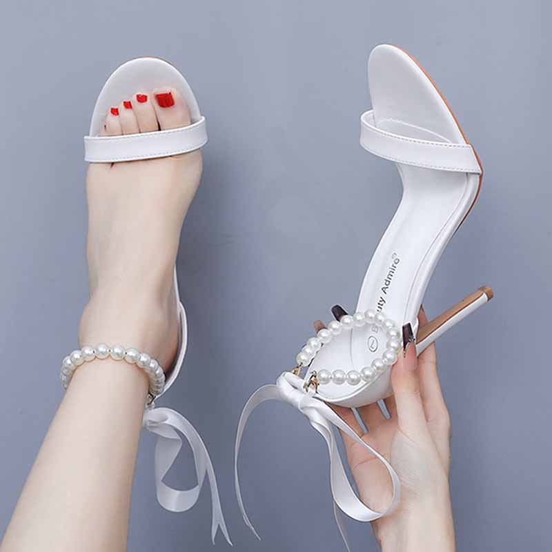 Elegant S&DCo pearl bridal heels featuring a chic design and ribbon ties for special occasions