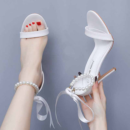 Elegant S&DCo pearl bridal heels featuring a chic design and ribbon ties for special occasions