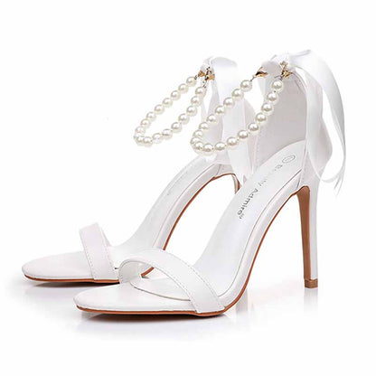 Elegant S&DCo. pearl bridal heels featuring a sleek design and pearl ankle straps for a stylish wedding look