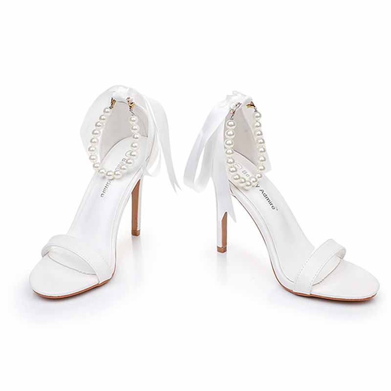 Elegant S&DCo. pearl bridal heels featuring a chic ribbon and pearl ankle strap