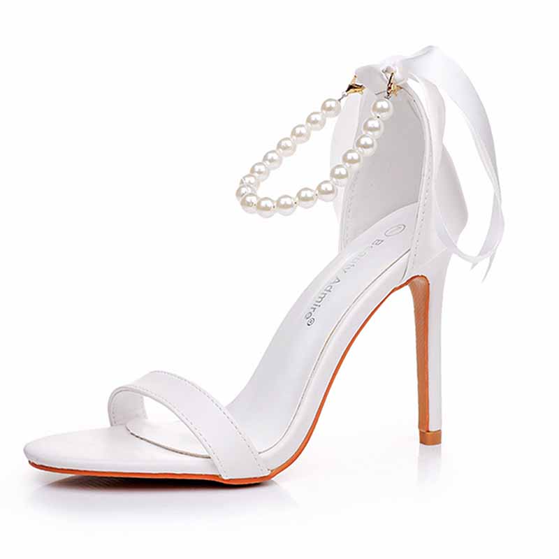 Elegant S&DCo. pearl bridal heels with ankle straps and a high stiletto for a chic wedding look