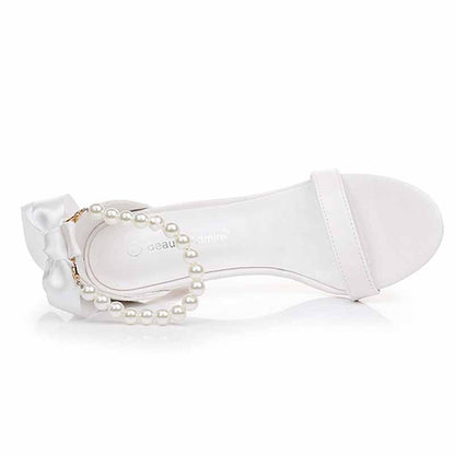 Elegant S&DCo. pearl bridal heels with satin bow and pearl detail for weddings and special events