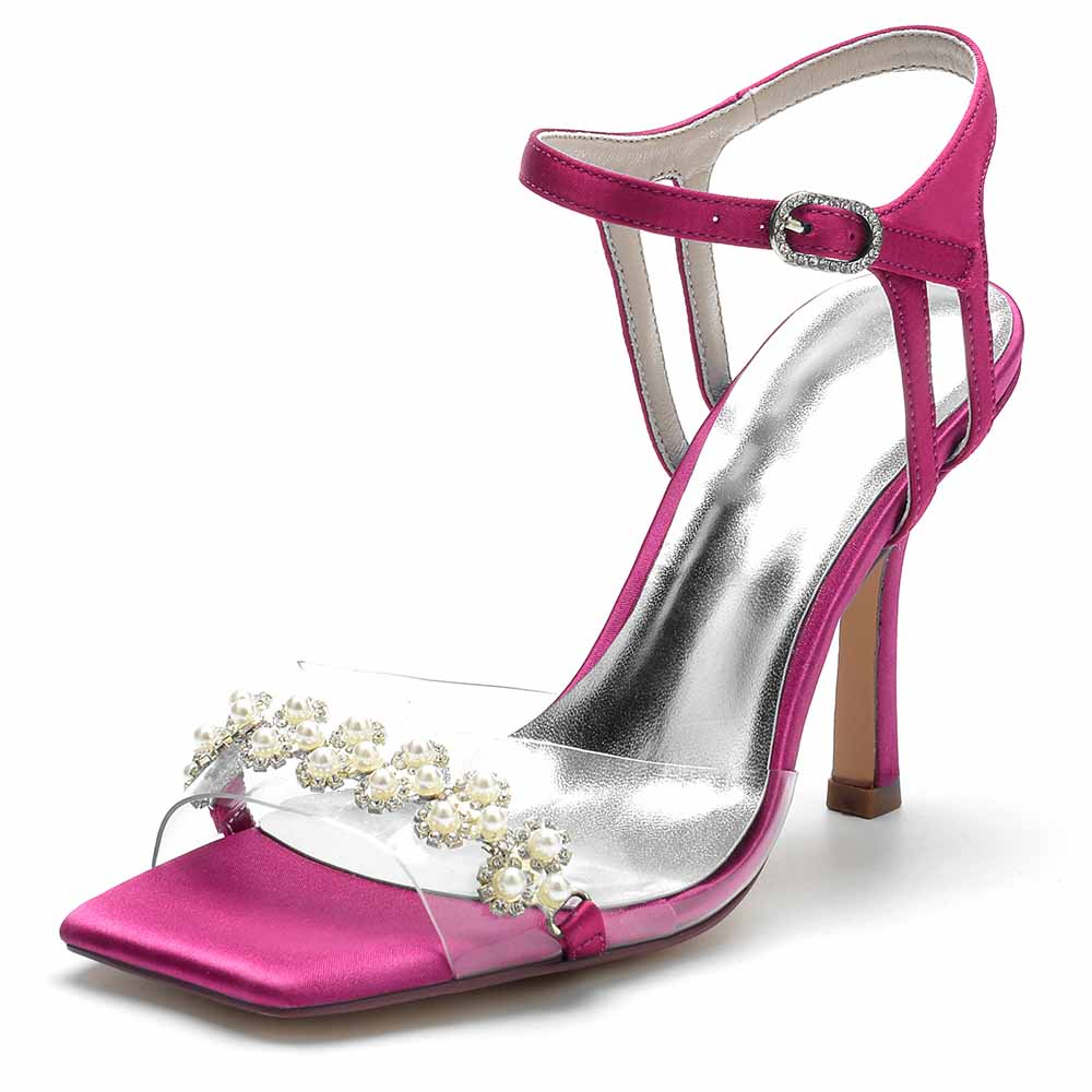 Pink satin S&DCo. pearl embellished prom heels with a clear strap and high heel design
