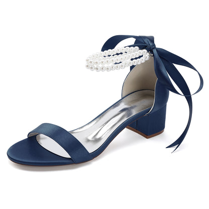 Navy pearl lace-up bridal sandals with a block heel and elegant ribbon ties for weddings