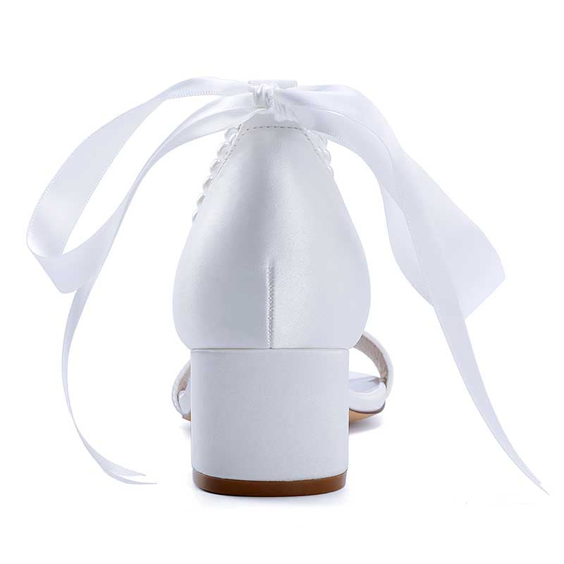 Elegant pearl lace-up bridal sandals with satin finish and long ribbon ties for a wedding look