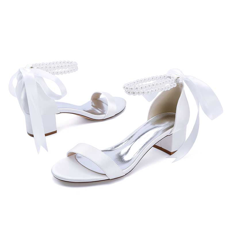 Elegant pearl lace-up bridal sandals with a stylish block heel and satin ribbon details