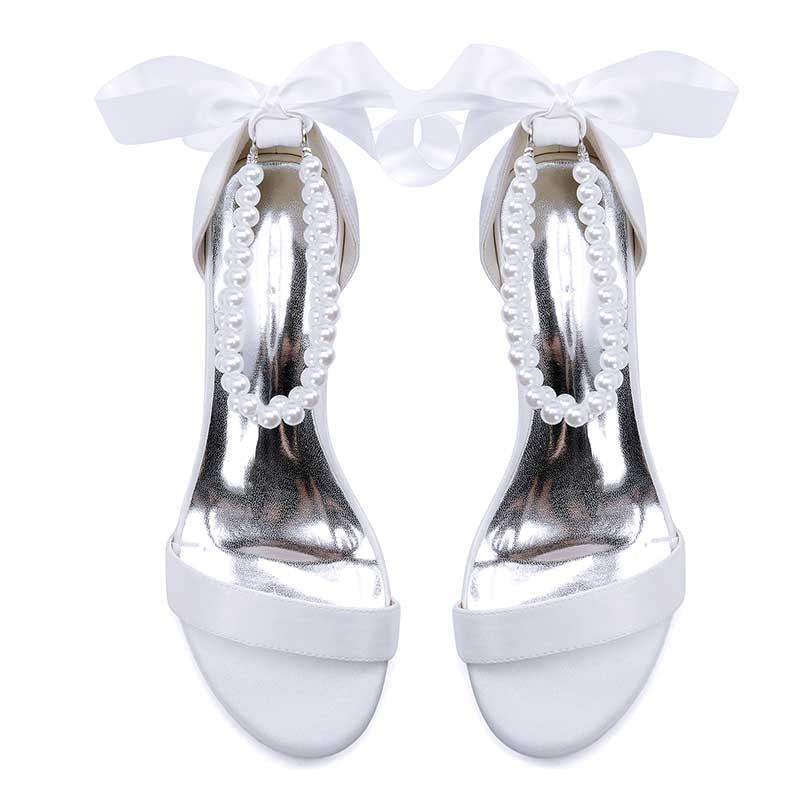 Elegant pearl lace-up bridal sandals with a satin ribbon and pearl detailing for weddings