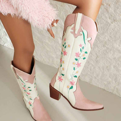 Pink embroidered cowgirl boots featuring floral designs and a stylish heel for Western fashion lovers