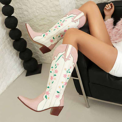 Stylish pink embroidered cowgirl boots with floral designs, perfect for trendy outfits