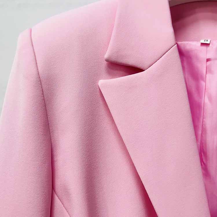 Close-up of a pink women's pantsuit for wedding featuring a stylish collar and soft fabric