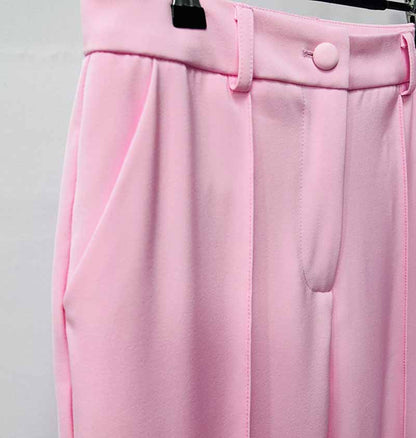 Detail of a pink women's pantsuit for wedding featuring pleated front and tailored fit