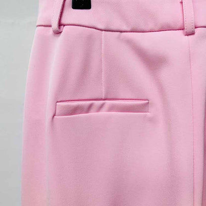 Close-up of a pink women's pantsuit for wedding featuring a smooth fabric and tailored pocket detail