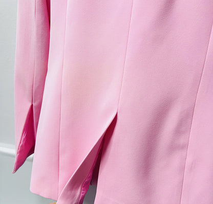 Stylish pink women's pantsuit for wedding with elegant tailoring and smooth fabric