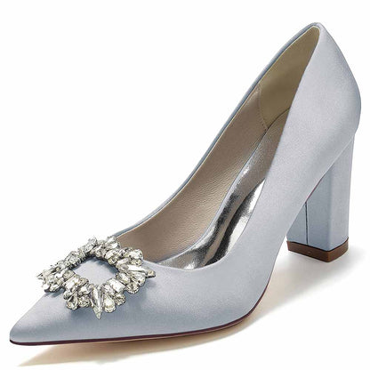Elegant point toe satin wedding shoes in light blue with a decorative rhinestone buckle detail