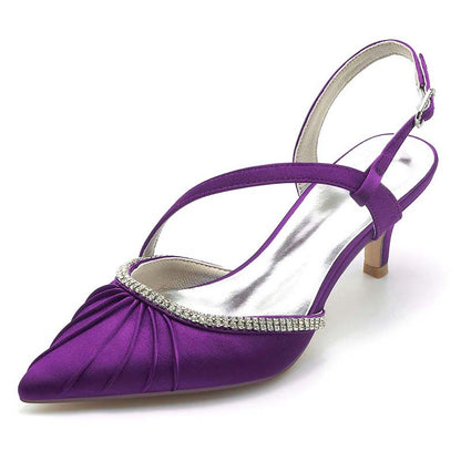 Purple high-heeled shoe with a rhinestone embellishment on a white background