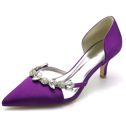 Purple high-heeled shoe with silver embellishments on a white background