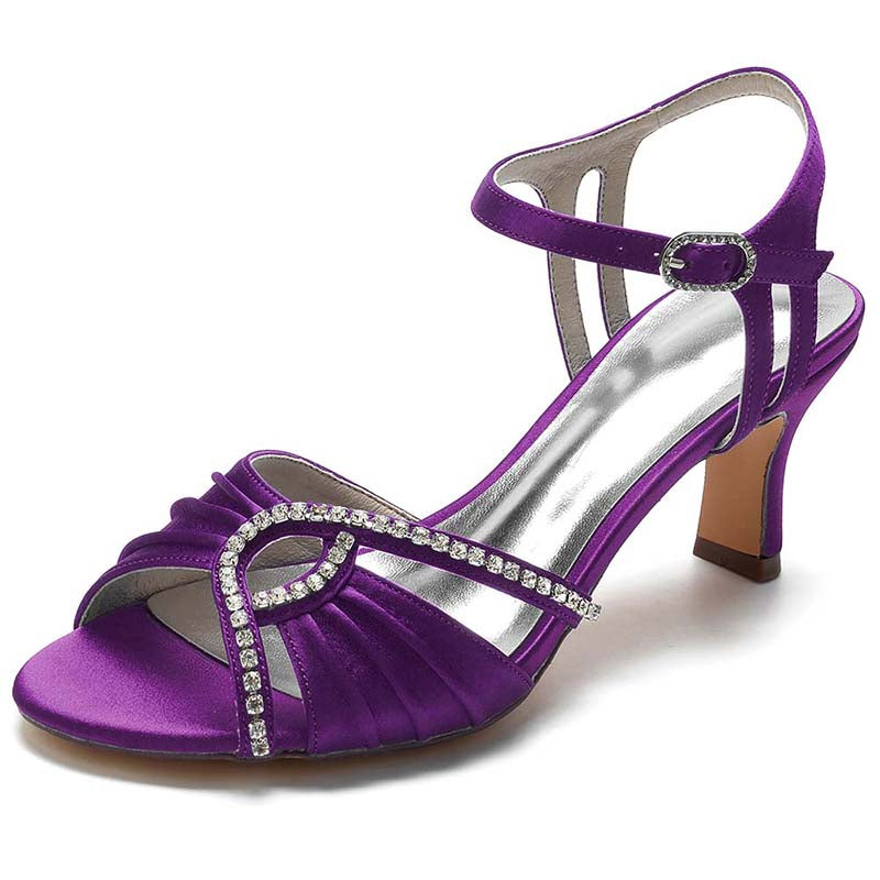 Purple sandal with rhinestone embellishments on a white background