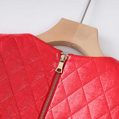 Close-up of the zipper detail on a vibrant red faux leather mini dress with a quilted design
