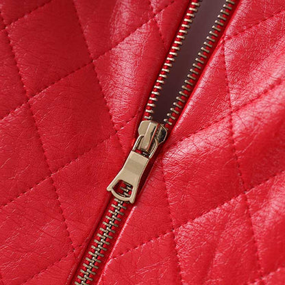 Close-up of the zipper on a red faux leather mini dress featuring a quilted design