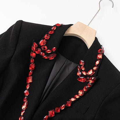 Rhinestone embellished black blazer featuring a stylish design and vibrant detailing