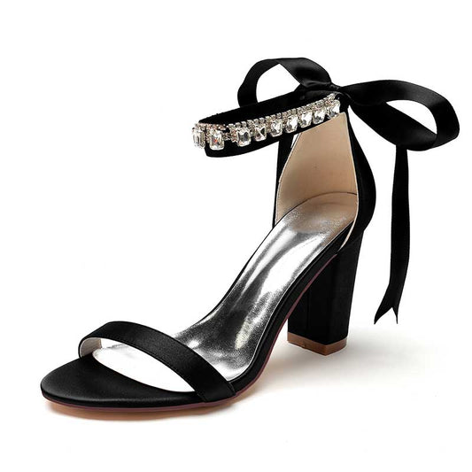 Elegant black heels featuring rhinestones and ribbon for a chic look, perfect as rhinestone prom shoes for women
