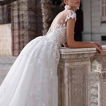 Stunning romantic lace wedding dress with sleeves featuring intricate embroidery and a flowing skirt