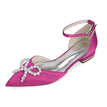 Satin bridal flats in pink with a pearl bow embellishment and elegant ankle strap