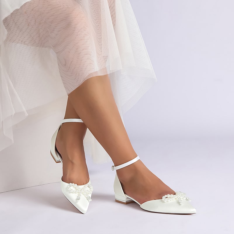 Elegant satin bridal flats with embellished details and ankle strap for a stylish wedding look