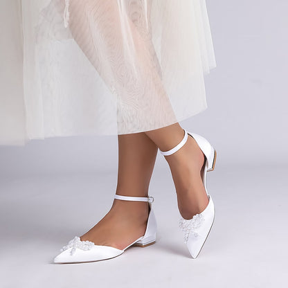 Elegant satin bridal flats with delicate floral embellishments and ankle strap design for brides