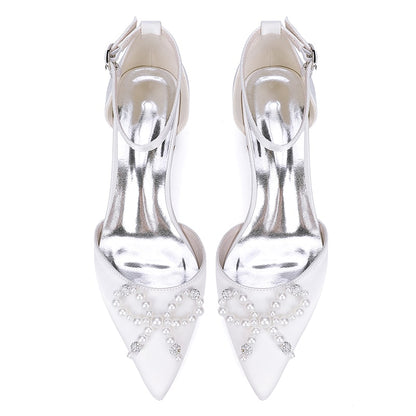 Elegant satin bridal flats with a pointed toe and pearl embellishments, perfect for weddings