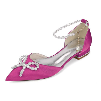 Pink satin bridal flats with pearls featuring a unique cross design and ankle strap