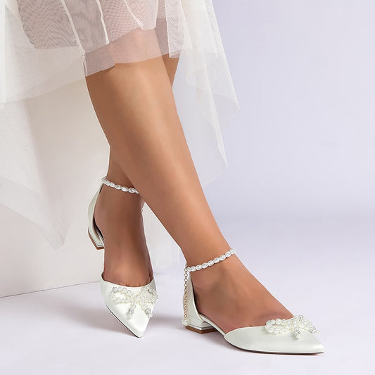 Elegant satin bridal flats with pearls, featuring a delicate bow for your wedding day style