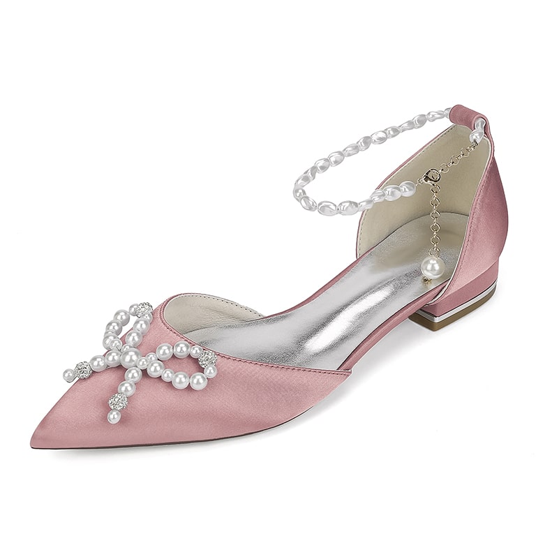 Pink satin bridal flats with pearls featuring a decorative bow and ankle strap for elegant weddings