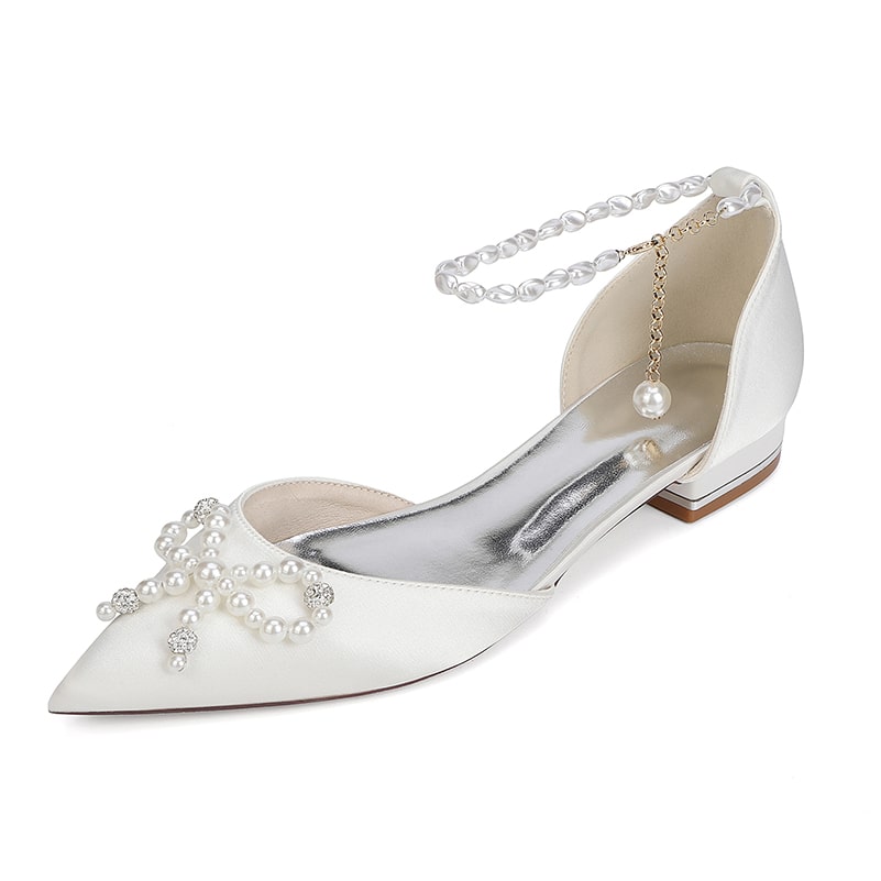 Elegant satin bridal flats with pearls featuring a pointed toe and ankle strap for wedding style