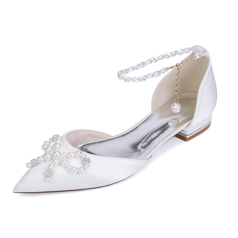 Elegant satin bridal flats with pearls and a delicate ankle strap for wedding footwear