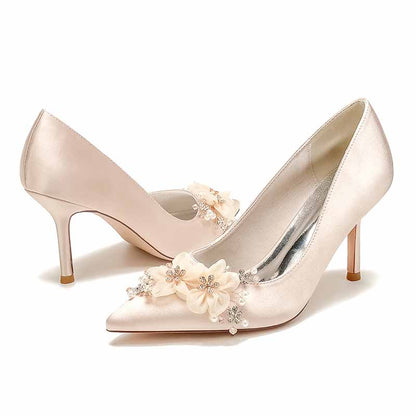 Champagne satin bridal heels with rhinestones and floral embellishments for a stylish wedding look