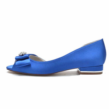 Open toe satin formal flats in royal blue with a decorative bow and gem detail