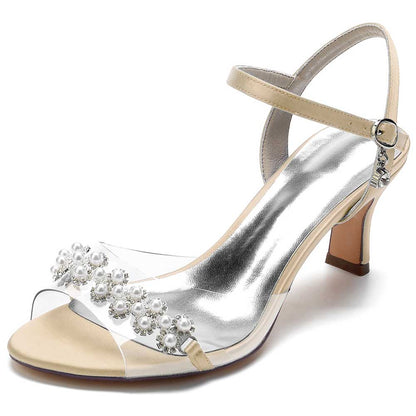 Elegant satin heeled sandals with pearls featuring a transparent strap and ankle buckle for a chic look