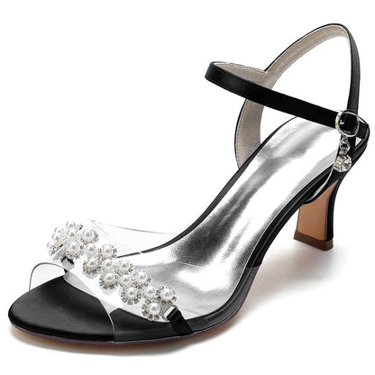 Elegant satin heeled sandals with pearls featuring a clear strap and stylish ankle closure