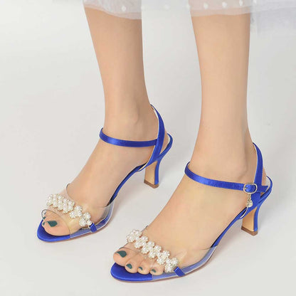 Blue satin heeled sandals with pearls featuring a transparent design and ankle strap for elegant style