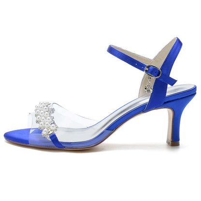 Stylish satin heeled sandals with pearls in blue featuring a clear strap and ankle buckle for elegance