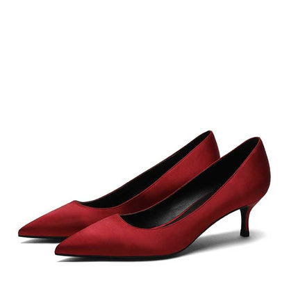 Elegant red satin low heel party shoes with a sleek pointed toe design for fashionable events