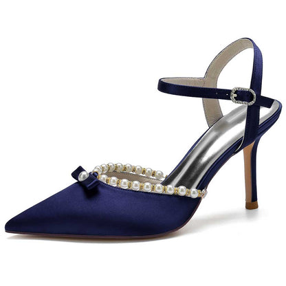 Elegant navy satin stiletto heels with pearls and a chic bow detail for sophisticated occasions