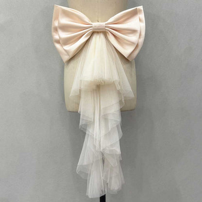 Satin wedding bow for bridal dress with layered tulle cascading from the center for an elegant look