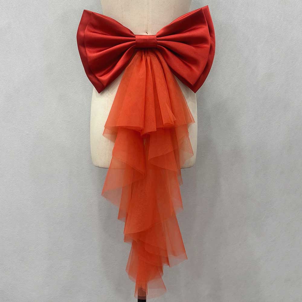 Satin wedding bow for bridal dress with dramatic tulle tail in vibrant red