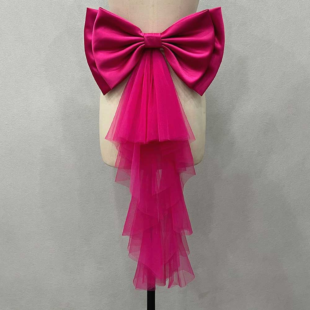 Pink satin wedding bow for bridal dress featuring a cascading tulle tail for a stylish look