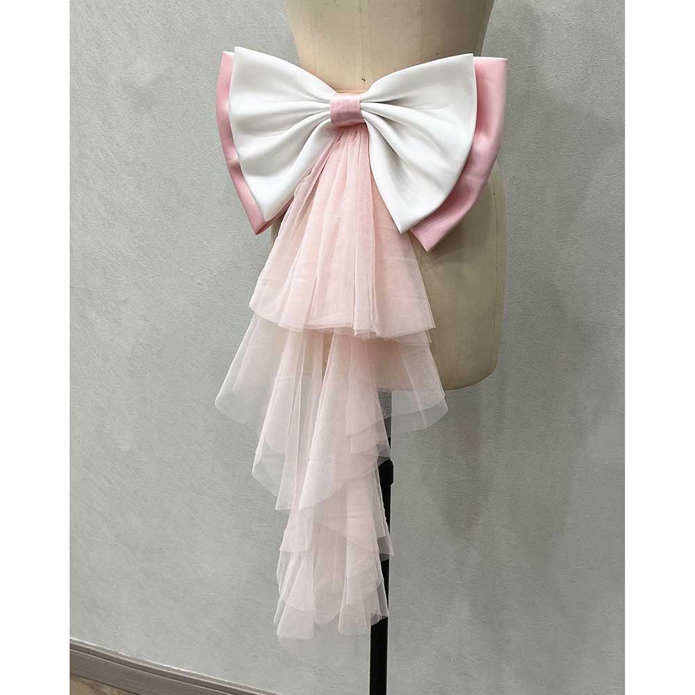 Satin wedding bow for bridal dress featuring a large white bow with pink accents and layered tulle details