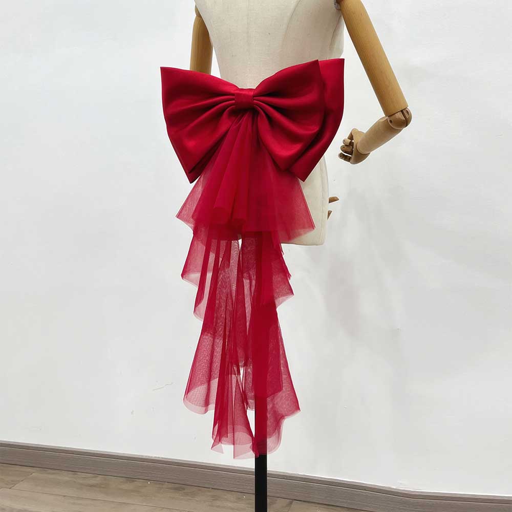 Elegant red satin wedding bow for bridal dress with flowing tulle overlay for a stunning look