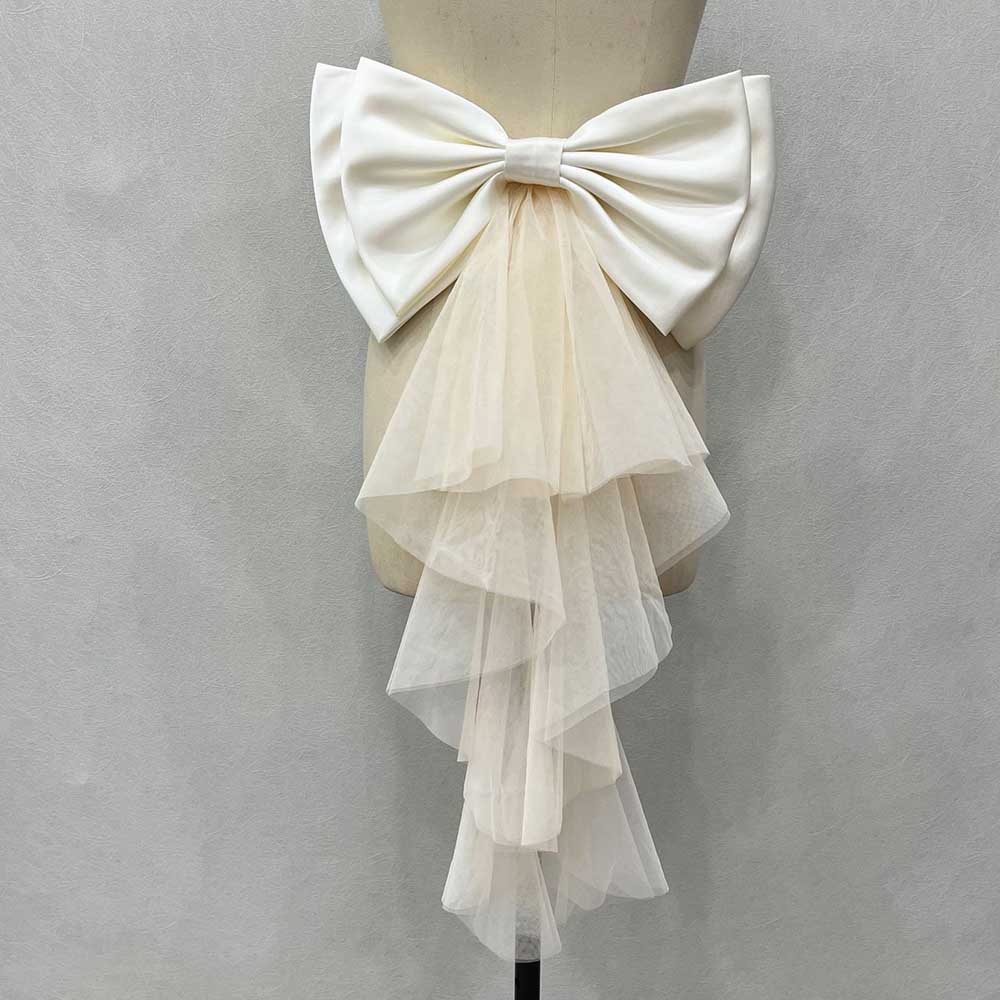 Satin wedding bow for bridal dress with a flowing tulle train, perfect for enhancing elegance