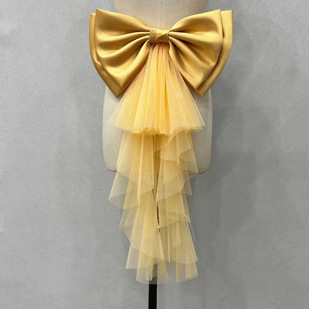 Satin wedding bow for bridal dress in golden color with tulle ruffles for a romantic look